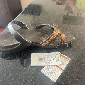 Croc Sandals.  Brown with metallic straps.  Brand new with tags.  Size 10.
